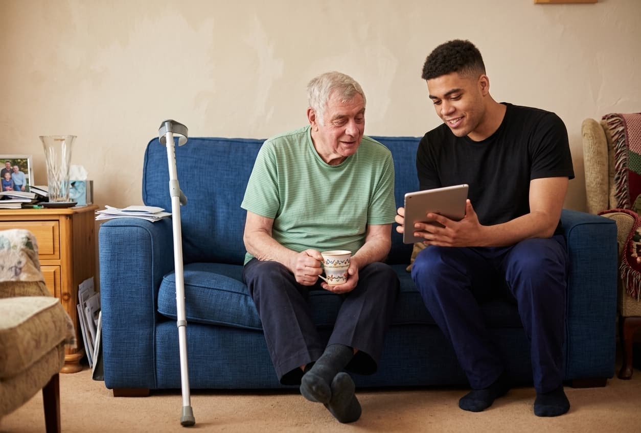 A ProxyKare caregiver sharing a supportive moment with an older adult.